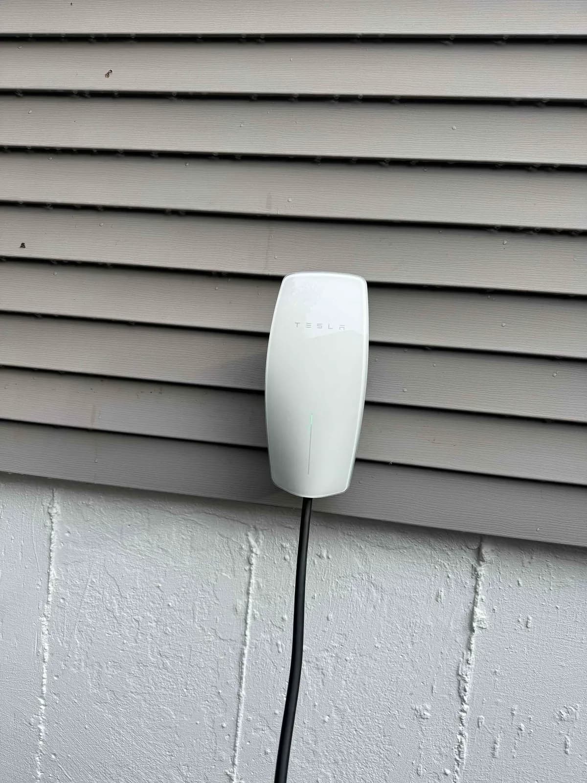 Tesla Wall Connector installed on the exterior of a home